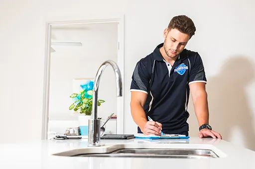 Plumber checking a kitchen tap