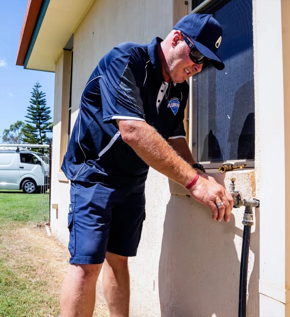 Plumber working on a hot water unit