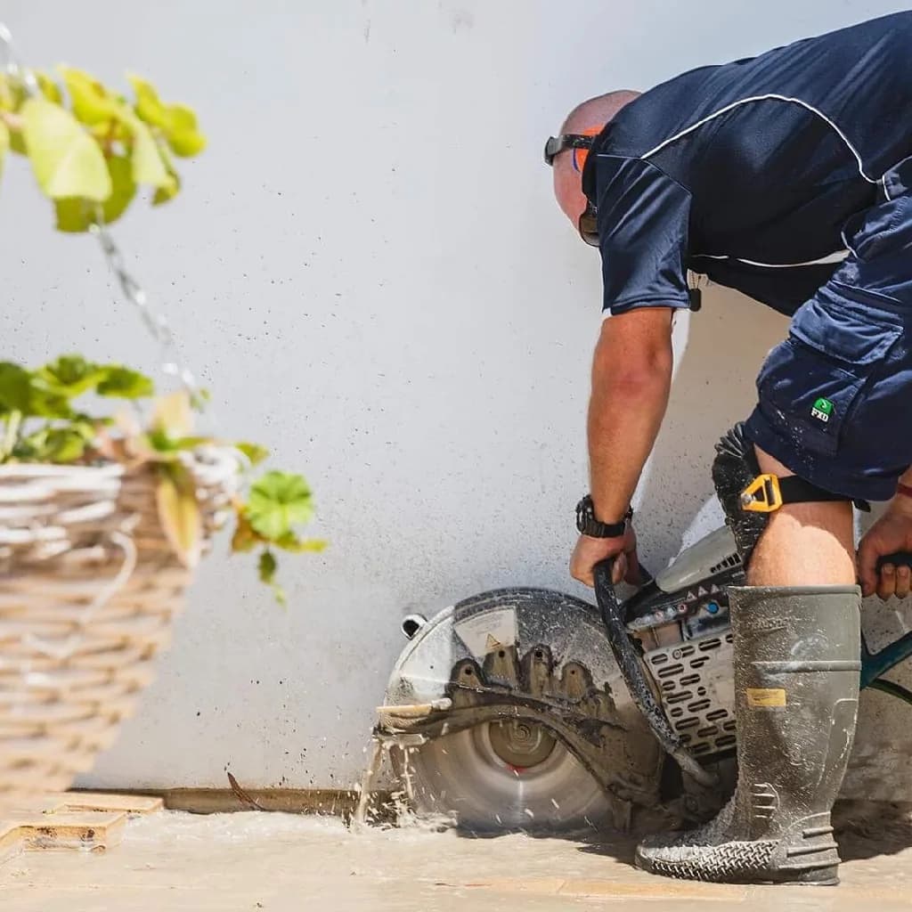 Plumber cutting a pipe
