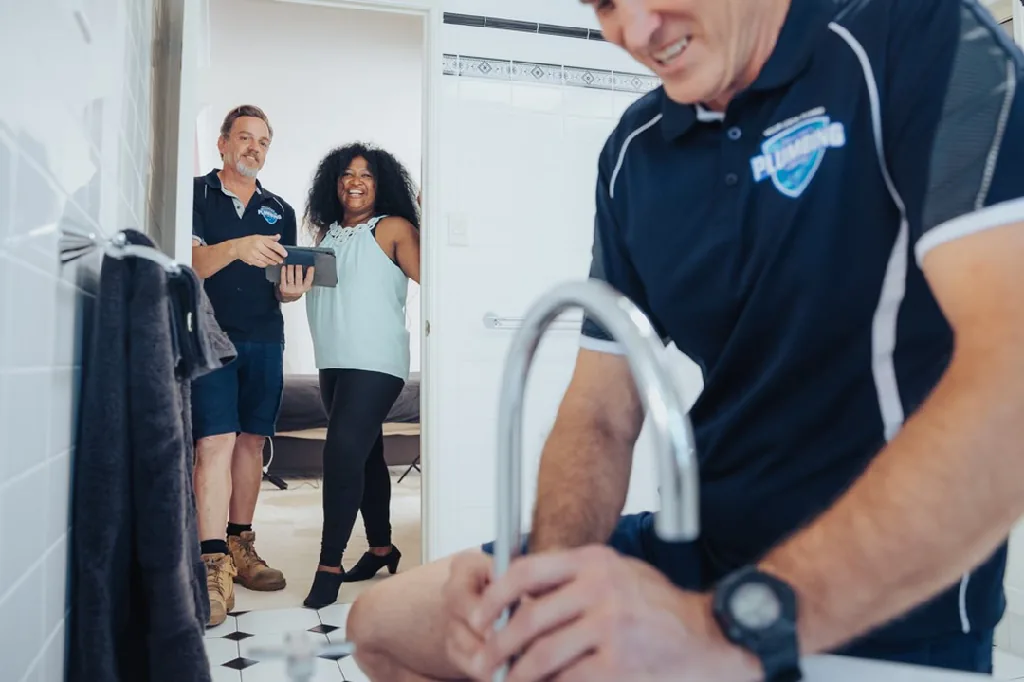 Plumber fitting a bathroom tap