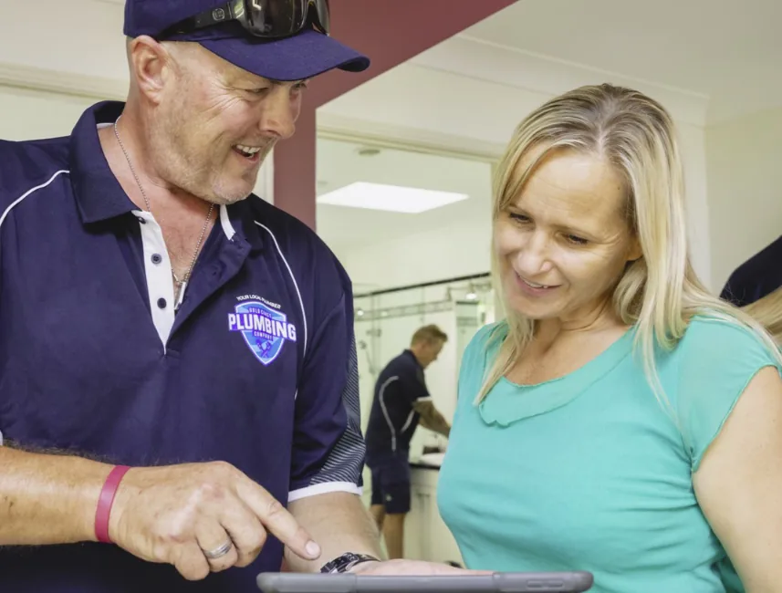 Plumber explaining a job to a customer