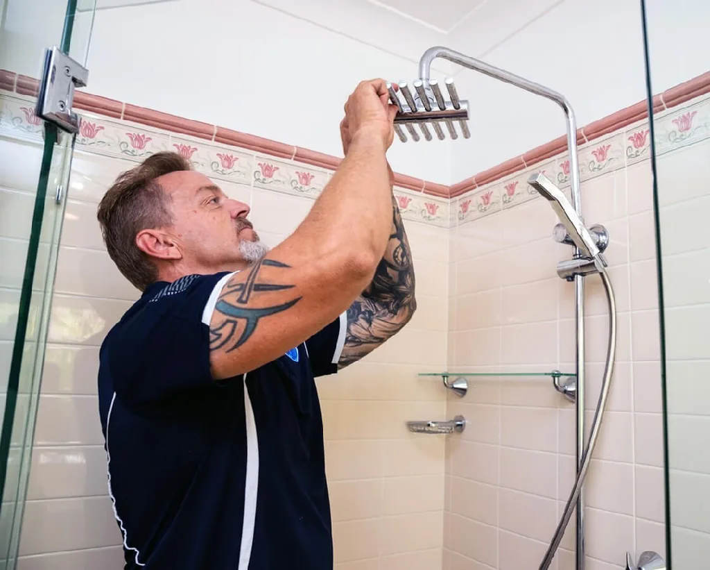 Plumber fitting a shower head