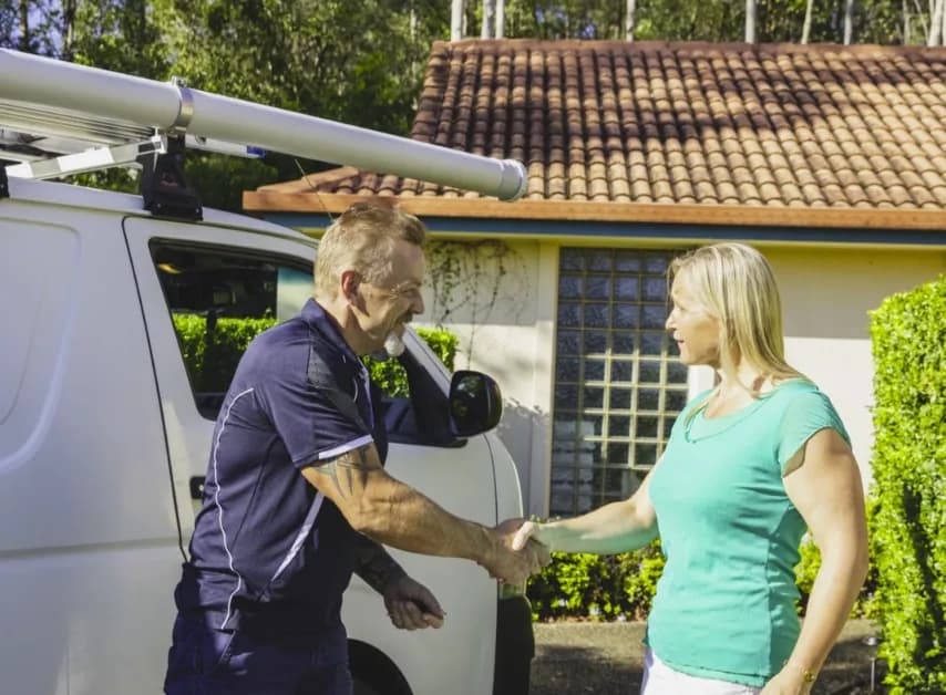 Plumber shaking hands with a customer