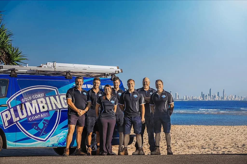 The team on the beach with the van