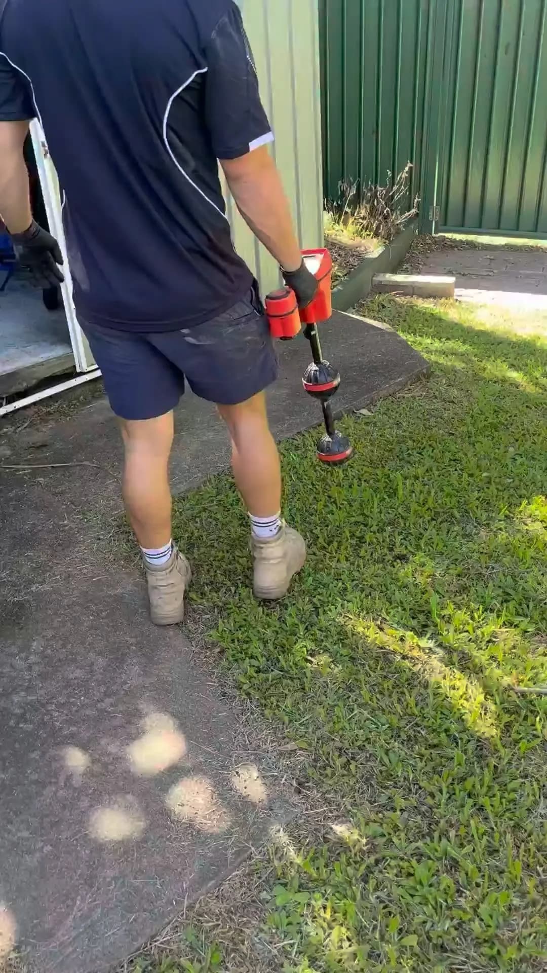 Plumber locating a leak in a yard